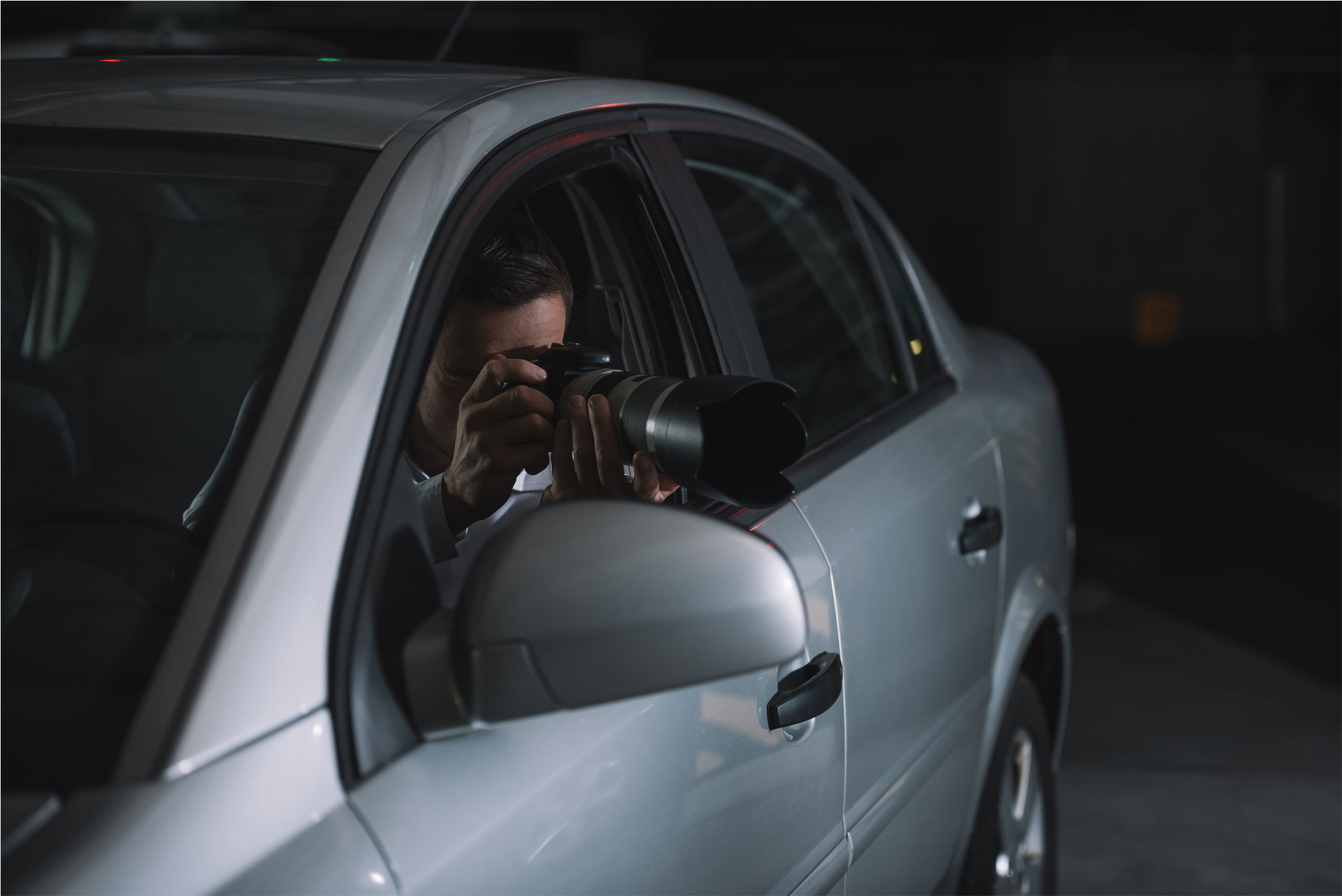 Private Investigator taking covert photos from a vehicle